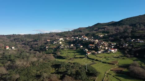 Sleepy-old-village-of-Soajo-built-up-on-hillside-in-Arcos-de-Valdevez-Minho-Portugal,aerial-orbit