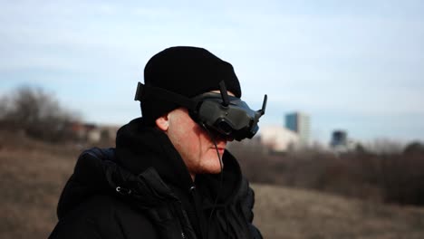 Man-put-wireless-connection-fpv-drone-goggles-on-eyes-and-prepare-for-flight
