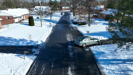 Aerial-view-of-a-car-turning-into-a-driveway