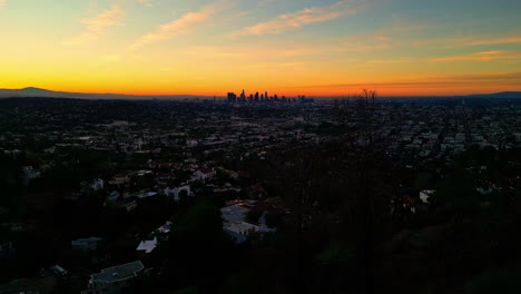 Iconic-skyline-of-Los-Angeles-during-sunrise,-aerial-drone-view