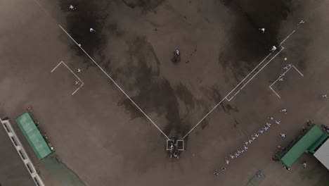 Aerial-Top-Drone-View-Above-Baseball-Match-Game,-Players-in-a-Dirt-Ground-Field