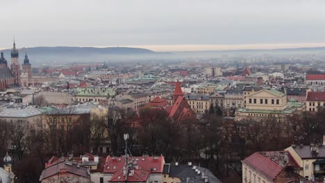 Krakow-antique-old-town-panorama-in-cloudy-morning-haze,-aerial-city-landscape