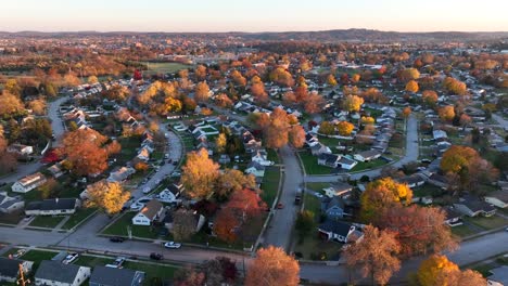 American-neighborhood-with-quaint-houses-among-colorful-fall-foliage-during-autumn-sunset