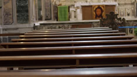 Rows-of-wooden-vacant-pews,-peaceful-church-interior-of-Saint-Fillipo-and-Giacomo