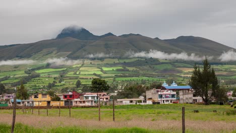 Time-lapse-of-the-parish-of-Aloasi-with-the-background-of-the-El-Corazon-or-Guallancatzo-volcano