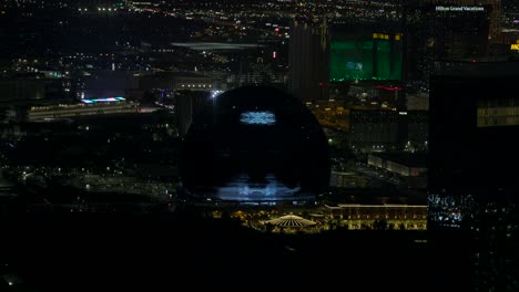 Illuminated-MSG-Sphere-With-Glitchy-Motion-Graphics-Being-Shown-At-Night-In-Las-Vegas