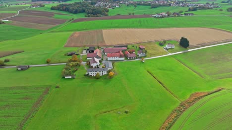 Houses-In-The-Middle-Of-Green-Fields-In-The-Countryside---Aerial-Drone-Shot