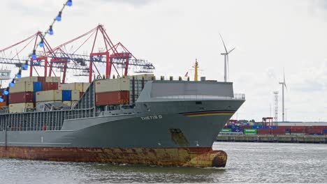 Static-shot-of-a-loaded-cargo-ship-passing-from-commercial-port-of-Hamburg-in-Germany