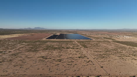 Aerial-shot-of-a-solar-panel-field-in-rural-southern-Arizona-near-picture-rocks,-wide-aerial-shot