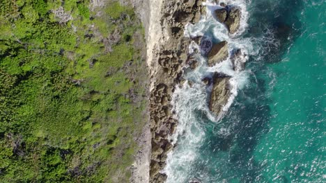Drone-flying-over-rocky-cliffs-of-Porte-d'Enfer,-Guadeloupe,-France