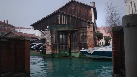Squero-di-San-Trovaso-boatyard-in-serene-Venice-canal,-Italy