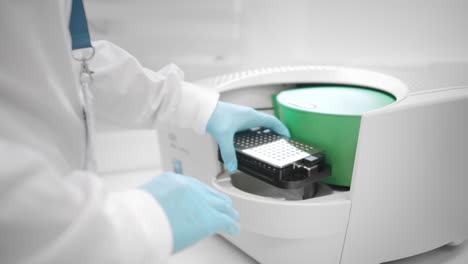 A-lab-assistant-places-samples-under-an-innovative-electron-microscope-for-pharmaceutical-bioscience-research