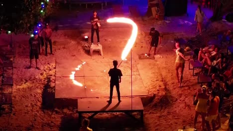 Tourists-at-Thai-beach-party-drinking-and-taking-turn-skipping-fire-rope