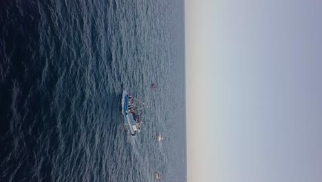 Vertical-view-of-a-fishing-boat-sailing-on-the-mediterranean-sea,-Catalunya,-Spain