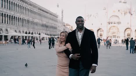 Lovely-mixed-race-couple-walking-over-the-most-famous-piazza-San-Marco-at-Palazzo-Ducale-in-Venice-Italy