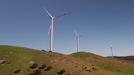 Wind-Farm---Wind-Turbines-On-Hills-Against-Blue-Sky