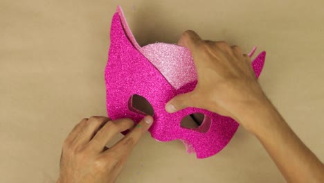 Measure-and-glue-pink-color-diamond-foam-with-your-hands,-carnival-mask