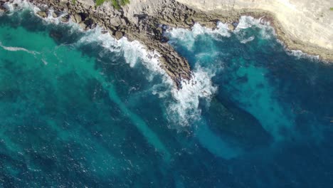 Waves-breaking-on-rocky-cliffs-of-Porte-d'Enfer-in-Guadeloupe,-France