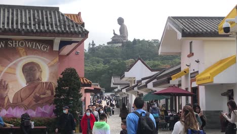 Tourists-visit-the-Big-Buddha-in-Ngong-Ping-Village,-Lantau-Island,-Hong-Kong