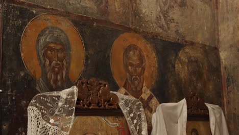 Close-up-of-an-ancient-hagiography-of-three-saints-in-a-Greek-orthodox-church