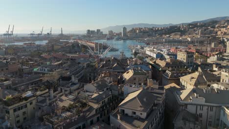Genoa's-historic-center-with-buildings-and-port,-clear-sky,-aerial-view