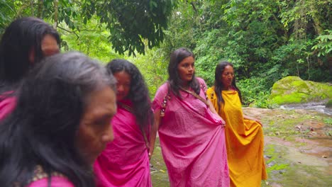 Family-walking-through-a-lush-green-forest-in-Oxapampa,-Peru,-wearing-vibrant-traditional-clothing,-playing-the-pan-flute,-displaying-cultural-heritage