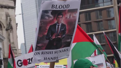 Palestine-Flags-Rise-Against-War-in-Gaza-Protest,-Blood-on-Rishi-Sunaks-Hands-Sign-at-London-England