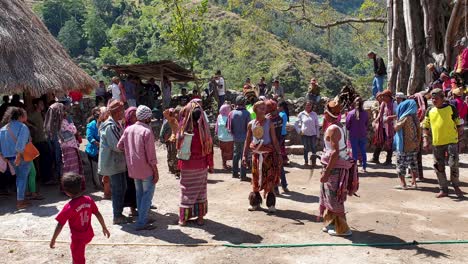 Local-community-of-Timorese-people,-men,-women-and-children,-wearing-traditional-cultural-clothes-attire-at-a-gathering-for-a-welcome-ceremony-in-East-Timor,-Southeast-Asia