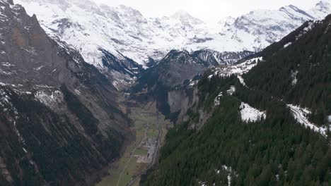 Impressive-Switzerland-mountain-valley-panorama-with-forest-and-snowy-peaks