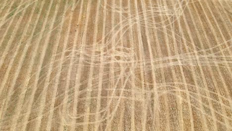 Aerial-View-Of-Tire-Tracks-On-Farm-Field-In-Aveyron,-France