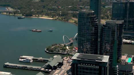 Aerial-Revealing-Elizabeth-Quay-Bridge-Behind-Downtown-Buildings-of-Perth,-Australia