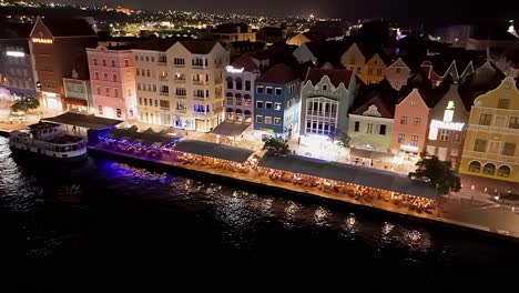Drone-establish-aerial-of-Handelskade-Willemstad-Curacao-at-night