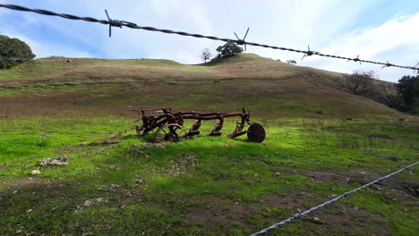 Abandoned-Farm-Equipment-On-Private-Land-With-Barbed-Wire-Fencing