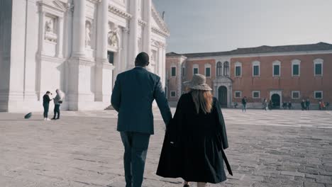 Well-dressed-mixed-race-couple-walking-over-Abbazia-di-San-Giorgio-maggiore-in-Florence-italy-like
