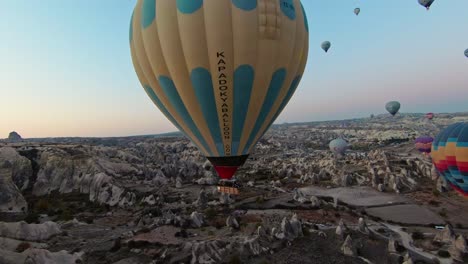 FPV-Of-Hot-Air-Balloons-Flying-During-Sunrise-In-Cappadocia,-Turkey