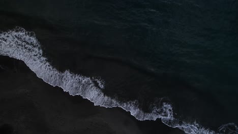 Waves-crashing-on-black-sand-beach,-Plage-de-Grande-Anse-bay,-Guadeloupe,-French-Antilles