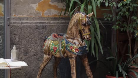 Handmade-sculpted-wooden-rocking-horse-outside-Italian-craft-shop