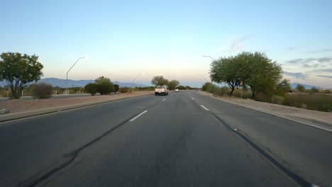 Point-of-view---Driving-in-near-sunset-in-Tucson-on-Golf-Links-Road---a-6-lane-expressway