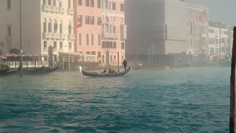 Misty-morning-in-Venice-Canals,-Gondola-ride-cruising-turquoise-waters