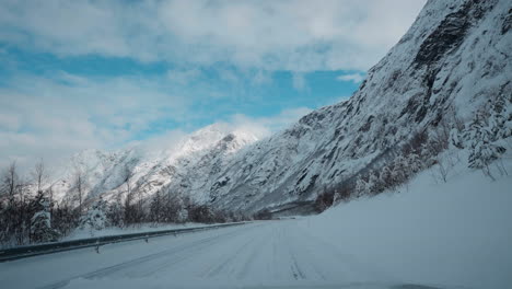 POV-driving-footage-on-snowy-mountain-roads-during-winter
