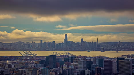 San-Francisco-city-skyline-and-bay-as-seen-from-Oakland-California---dramatic-daytime-cloudscape-time-lapse