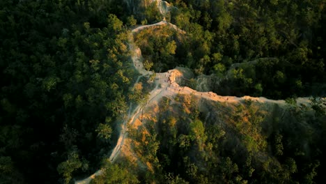 4K-Cinematic-nature-aerial-drone-footage-of-the-beautiful-mountains-of-Mae-Hong-Son-at-the-famous-canyon-next-to-Pai,-Thailand-during-sunset