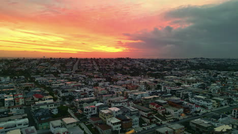 Endless-cityscape-of-Los-Angles-with-burning-sunrise-sky,-aerial-view
