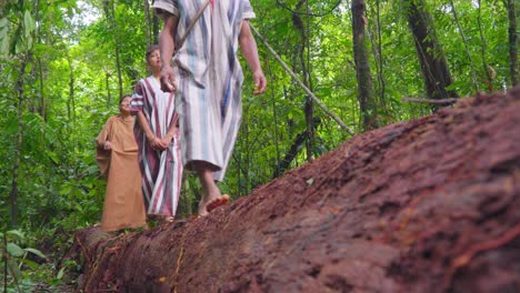 Indigenous-people-walking-in-Oxapampa-forest,-dressed-in-traditional-clothes,-low-angle-view