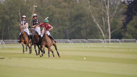 Polo-player-pushes-another-player-out-of-the-way-whilst-on-horseback-at-full-gallop