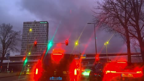 Cars-with-red-waiting-lights-waiting-in-front-of-stoplight-pov-through-window