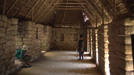 Inside-the-strtucture-of-a-kancha-made-by-Incas-with-precision-,-a-mix-of-perfectly-carved-stones-that-fit-together-that-no-glue-is-needed,-with-wooden-logs-made-of-straw-for-the-roof