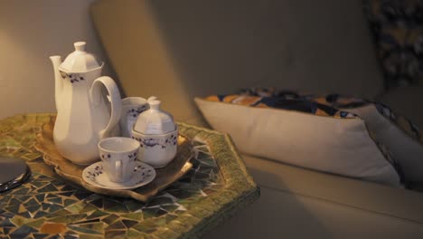 Cozy-teatime-setup-with-mosaic-table-and-cushion