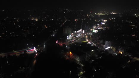 Rajkot-aerial-drone-view-where-many-vehicles-are-moving-around-the-circle,-many-vehicles-are-visible-and-there-are-also-big-complexes-nearby