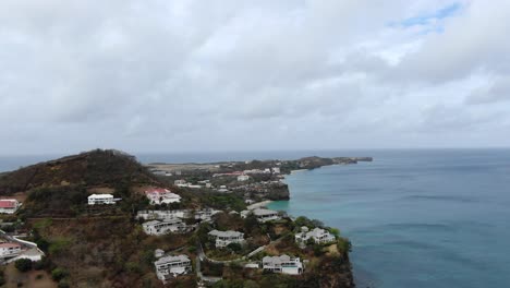 Luxury-homes-on-tropical-peninsula-in-Caribbean-sea,-Grenada-aerial
